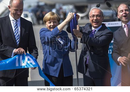 BERLIN, GERMANY - MAY 20, 2014: German Chancellor Angela Merkel, Turkish Minister of transport Lutfi Elvan and CEO Mr Christian (C.-R.) open up the International aviation and space exhibition ILA.