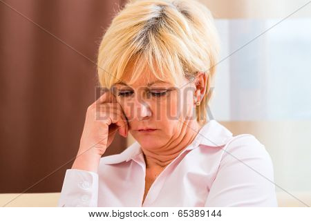 Old woman touching forehead having headache or migraine