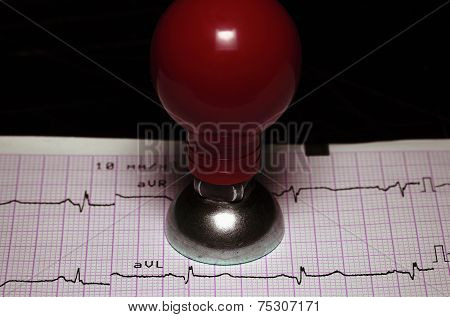 Cardiology, Healthcare Concept. Ecg And A Metal Electrode.