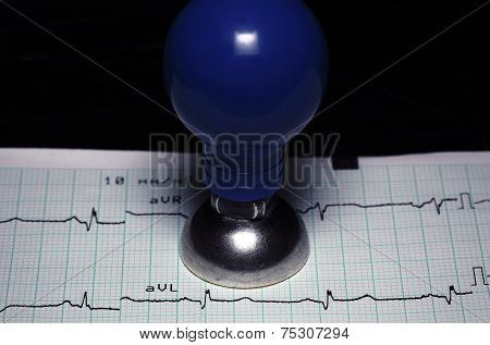 Cardiology, Healthcare Concept. Ecg And A Metal Electrode.