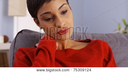 Sad African Woman Sitting On Couch