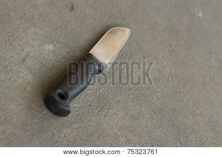 A Kitchen Knife On A Gray Background.