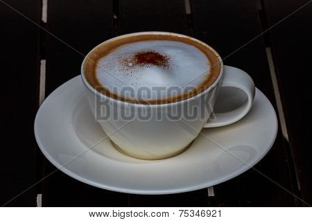 Coffee Cup On Wooden Table On Brown Background