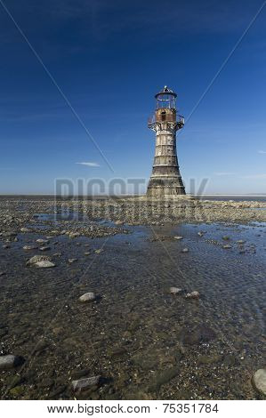 Ruined Derelict Lighthouse, Whiteford Sands, Gower Peninsula, South Wales. Blue Sky.