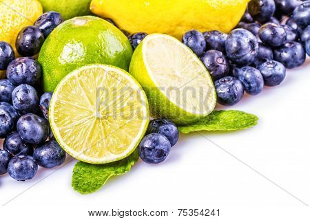 Fresh blueberries green leaves, citrus fruit - lemon limet
