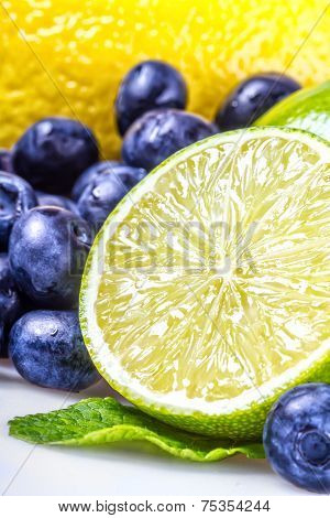 Fresh blueberries green leaves, citrus fruit - lemon limet