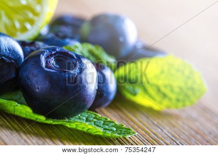 Fresh blueberries green leaves, citrus fruit - lemon limet