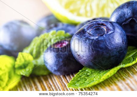 Fresh blueberries green leaves, citrus fruit - lemon limet