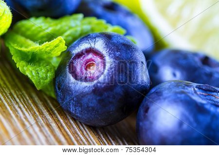 Fresh blueberries green leaves, citrus fruit - lemon limet