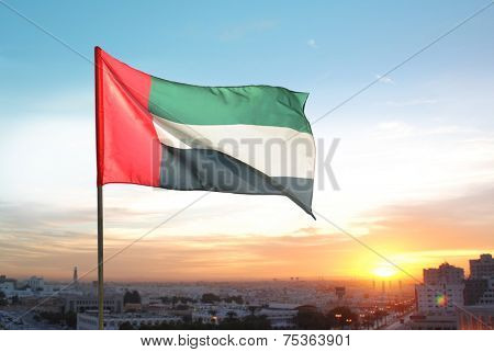 A big flag of UAE flying high on the city of Sharjah, UAE. A National Day celebration on 2nd December.