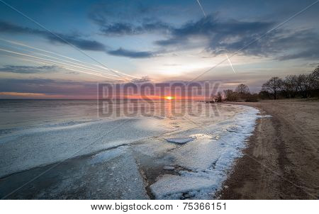 Sunset at frozen bay