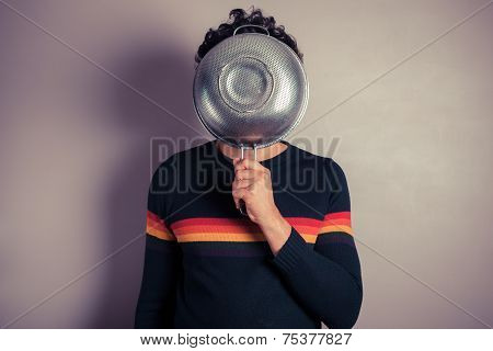Young Man Hiding Behind Collander