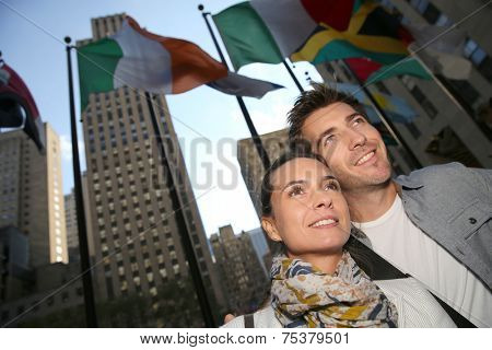 Couple standing by the Rockfeller center in New York City