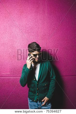 Model Man Talking With A Smart Phone Over Fuchsia Background