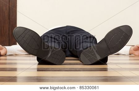 Drunkard. Young exhausted businessman lying on the floor