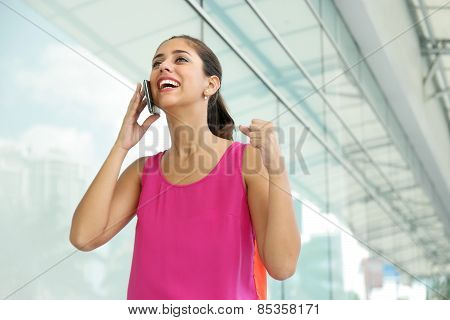 Young Woman On The Phone Smiling For Joy