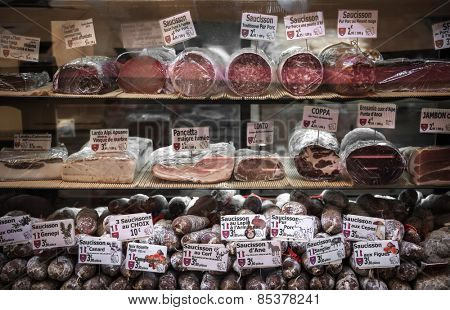 NICE, FRANCE - OCTOBER 2, 2014: Cured meats on display in butcher shop on Rue Pairoliere, a quaint pedestrian shopping street in old Nice.