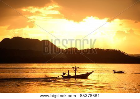 Traditional Fisherman Long Tailed Boat In Koh Phitak Island, Thailand At Sunset.