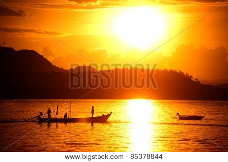 Traditional Fisherman Long Tailed Boat In Koh Phitak Island, Thailand At Sunset.