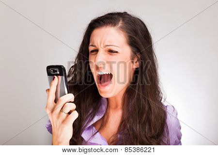 Angry woman shouting to a cell phone