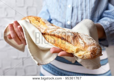 Woman holding tasty fresh bread, close up