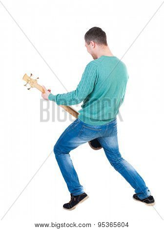 Back view young man with a guitar. Rock star with a musical instrument.  Rear view people collection.  backside view person.  Isolated over white background. Young bass player plays with enthusiasm.