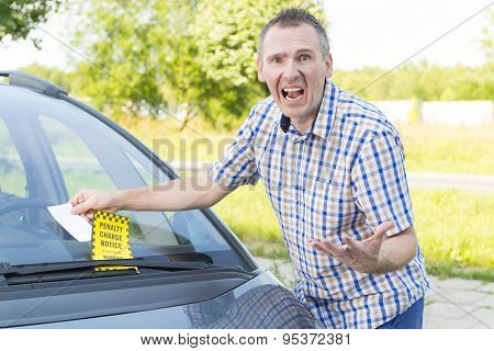 Suprised screaming man looking on parking ticket placed under windshield wiper
