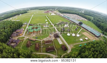 RUSSIA, BOROVSK - JUN 13, 2014: Aerial view of tourists walk by territory of cultural complex Etnomir at ethnofestival Wild mint. Photo with noise from action camera