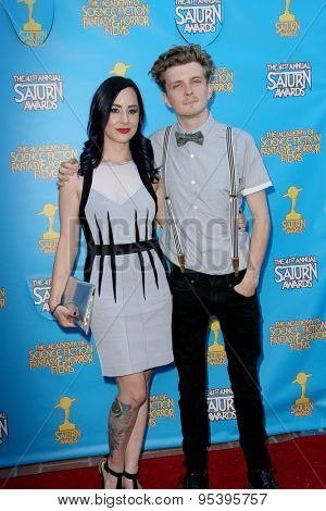 BURBANK - JUNE 25: Erik Knudsen and guest arrive at the 41st Annual Saturn Awards on Thursday, June 25, 2015 at the Castaway Restaurant in Burbank, CA.