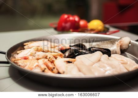 Italian pasta fideua with seafood, oysters, black pasta