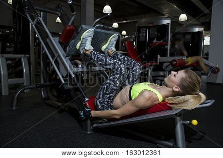 Young Woman Goes In For Sports At Gym