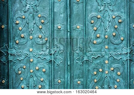 Old wrought-iron gates. Blue door with a pattern.
