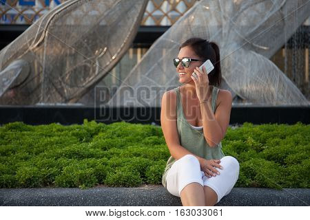 Young girl talks on the smartphone and siles