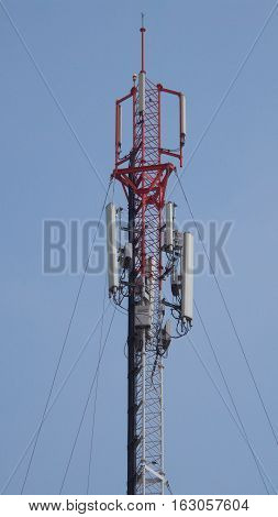 Close-up to antenna tower and clear blue sky background