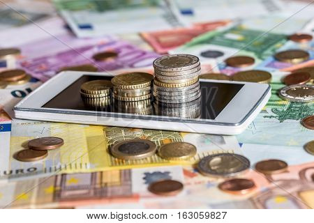 Euro bills and wuro coin and phone
