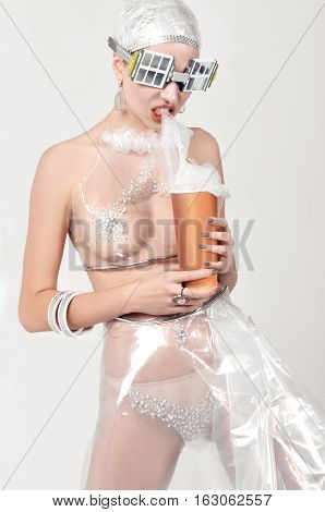 Girl Eats Plastic, Instead Of Popcorn. She Is Dressed In An Unnatural Clothes