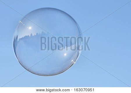 Soap bubble, flying in the air and reflective environment