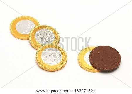 Euro chocolate wrapped in metal foil on a white background