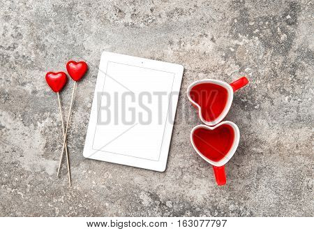 Tablet PC with Red Heart Decoartion and Tea Cups. Valentines Day concept with space for Your text and picture