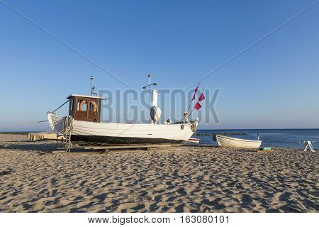 A Fishing Boat On Shore Of The Baltic Sea In Koserow, Germany.