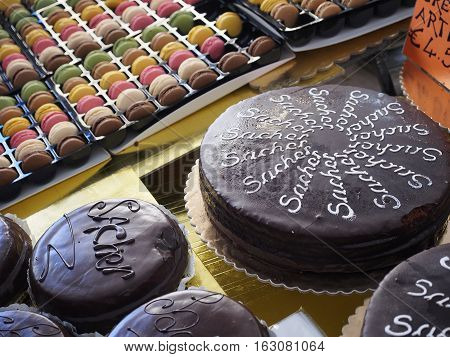Sachertorte (cake) on sale on a stand full of delicious food.