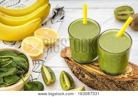 Fresh and healthy green smoothie with spinach,banana and kiwi. Vegetarian breakfasts. Picture with space for text or logos.