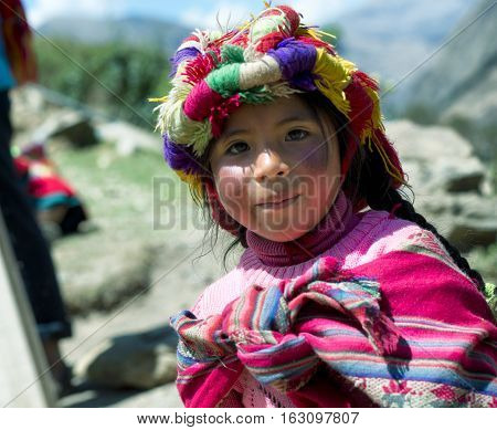 Portrait of a Peruvian girl dressed in colourful traditional handmade outfit. October 21 2012 - Patachancha Cuzco Peru