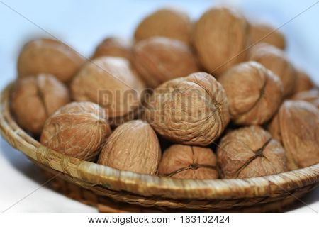 Macro Photo Of Nuts In Straw Plate.
