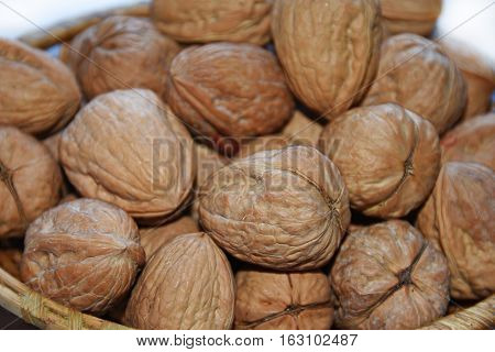 Macro Photo Of Nuts In Straw Plate.