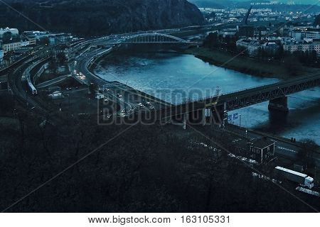 Usti nad Labem Ustecky kraj Czech republic - November 20 2016: evening cityscape with river elbe two bridges train and automobile traffic