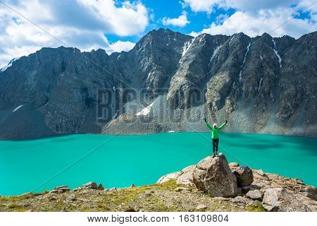 A Woman Stands On A Huge Stone On The Background Of The Lake Ala-kul, Kyrgyzstan.