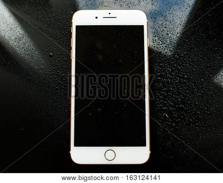 PARIS FRANCE - SEP 26 2016: New Apple iPhone 7 Plus under rain waterdrops. New iPhone7 is one of the best waterproof smartphone in the world