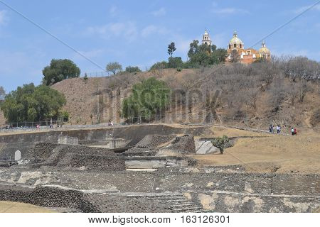 Church and Ruins. Our Lady of the Remedies church stands on the top of what looks like an ordinary hill but is really the Great pyramid of Cholula, Puebla Mexico
