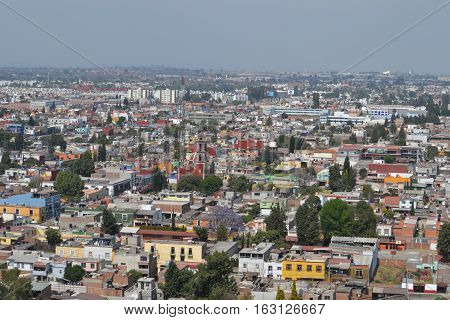 View of the city of Cholula from the top of a pyramid. The city has over 365 church so no matter where you look you will see one or more. Puebla, Mexico